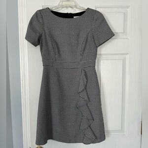 Black and white herringbone pattern mini dress with ruffle detail!